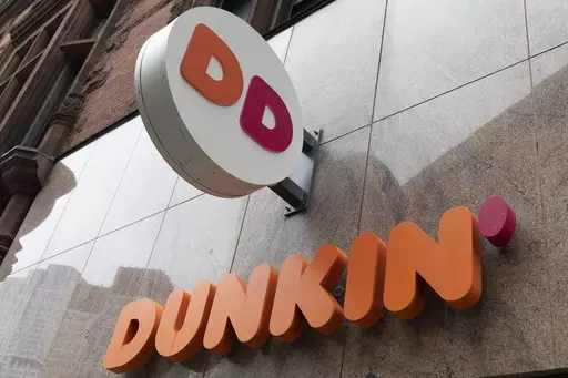 The Dunkin' logo is seen on a storefront, Friday, Oct. 14, 2022, in Boston. Reward programs have long been a way for brands to build loyalty and incentivize spending. But now some companies are becoming a bit more stingy, and customers are taking notice. Last fall, for example, many balked at Dunkin's decision to stop offering a free drink on their birthday and instead give them triple loyalty points on their purchase. (AP Photo/Michael Dwyer, File)