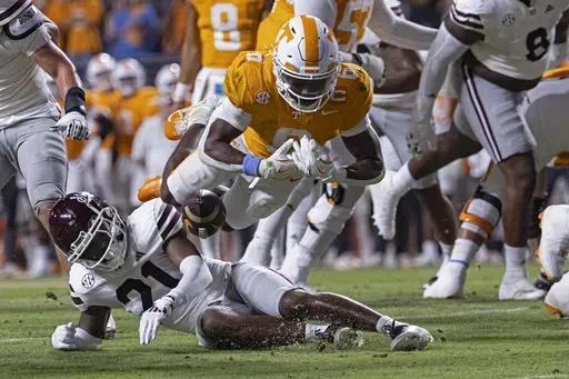 Tennessee running back Dylan Sampson (6) fumbles the ball as he's hit by Mississippi State safety Hunter Washington (21) during the first half of an NCAA college football game Saturday, Nov. 9, 2024, in Knoxville, Tenn. (AP Photo/Wade Payne)