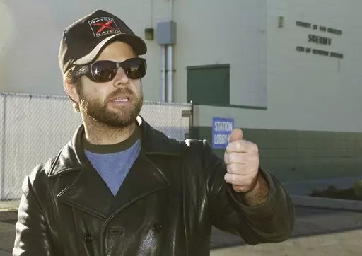 One-time child actor Adam Rich, who starred in the 1970s TV show "Eight is Enough," walks out of a sheriff's station after posting bail in City of Industry, Calif., Dec. 18, 2002. Rich, the child actor with a pageboy mop top who charmed TV audiences as “America's little brother” on “Eight is Enough,” died Saturday, Jan. 7, 2023, in the Brentwood section of Los Angeles. He was 54. The cause of death was under investigation but was not considered suspicious. (AP Photo/Jean-Marc Bouju)