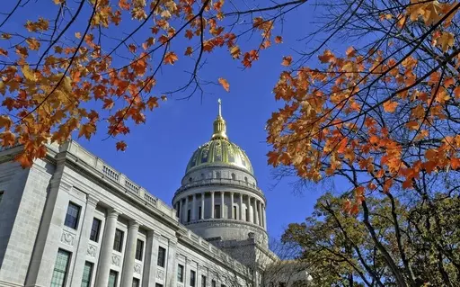 The West Virginia Capitol with its dome framed by turning sugar maples leaves is seen, Nov. 3, 2014, in Charleston, W.Va. Lawmakers in West Virginia's GOP-controlled state Legislature voted Saturday, March 9, 2024, to allow some students who don't attend traditional public schools to be exempt from state vaccination requirements that have long been held up as some of the most strict in the country. (Tom Hindman/The Daily Mail via AP, File)