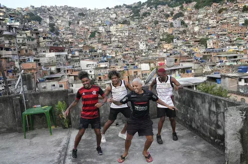 Youth perform a street dance style known as passinho for their social media accounts, in the Rocinha favela of Rio de Janeiro, Brazil, Wednesday, April 17, 2024. The passinho, or “little step”, created in the 2000s by kids in Rio’s favelas, was declared an “intangible cultural heritage” by state legislators, bringing recognition to a cultural expression born in the sprawling working-class neighborhoods. (AP Photo/Silvia Izquierdo)