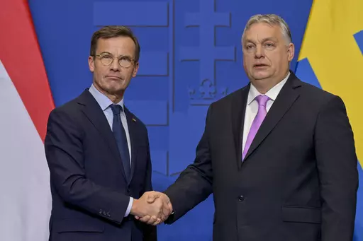 Sweden's Prime Minister Ulf Kristersson, left, shakes hands with his Hungarian counterpart Viktor Orban at the Carmelite Monastery in Budapest, Hungary, Friday, Feb 23, 2024. As Sweden joins NATO, it bids a final farewell to more than two centuries of neutrality. (AP Photo/Denes Erdos, File)