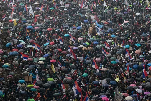 People gather in front of the Serbian parliament during a major anti-corruption rally led by university students in Belgrade, Serbia, Saturday, March 15, 2025. (AP Photo/Marko Drobnjakovic)