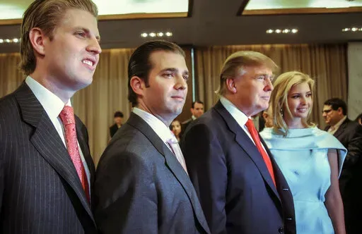 Donald Trump, chairman and CEO of the Trump Organization, poses with his children, from left, Eric, Donald Jr. and Ivanka, at the opening of the Trump SoHo New York on April 9, 2010. Trump must answer questions under oath in New York state’s civil investigation into his business practices, a judge ruled Thursday, Feb. 17, 2022. Judge Arthur Engoron ordered Trump and his two eldest children, Ivanka and Donald Trump Jr., to comply with subpoenas issued in December by New York Attorney General Le