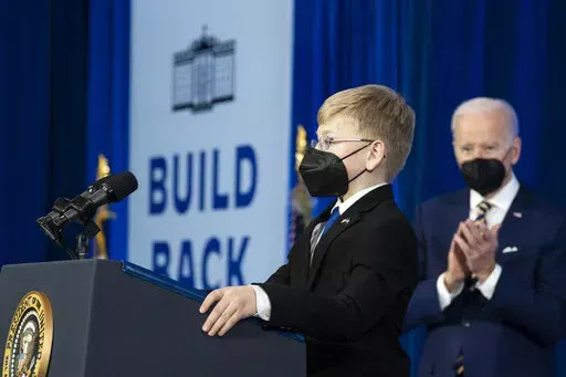 Joshua Davis, 12, introduces President Joe Biden to speak about prescription drug costs at the Daniel Technology Center of Germanna Community College – Culpeper Campus, Thursday, Feb. 10, 2022, in Culpeper, Va. (AP Photo/Alex Brandon)