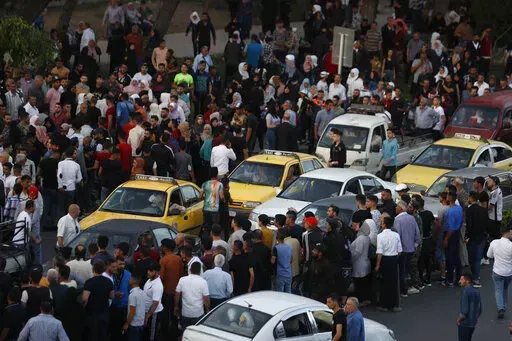 Dozens of Syrians wait at the President's Bridge in Damascus for relatives they hope would be among those released from prison May 3, 2022, on the second day of the Muslim Fitr holiday. A newly released video taken in 2013 showed blindfolded men who were thrown into a large pit and shot dead by Syrian agents, who then set the bodies on fire. The video stirs new fears over the fate of tens of thousands who went missing during Syria's long-running conflict and serves as a grim reminder of the war'