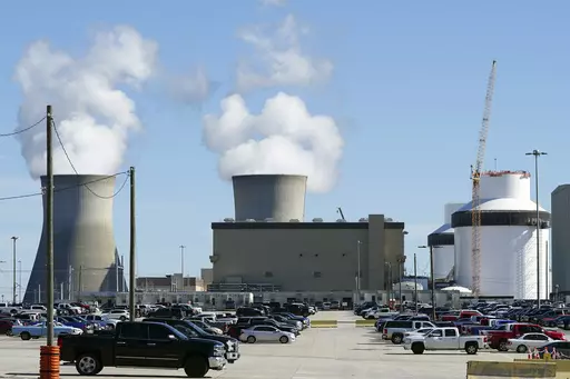 Reactors for Unit 3 and 4 sit at Georgia Power's Plant Vogtle nuclear power plant on Jan. 20, 2023, in Waynesboro, Ga., with the cooling towers of older Units 1 and 2 billowing steam in the background. Company officials announced Wednesday, May 24, 2023, that Unit 3 would reach full power in coming days, after years of delays and billions in cost overruns. (AP Photo/John Bazemore)