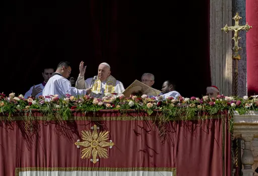 Pope Francis bestows the plenary 'Urbi et Orbi' (to the city and to the world) blessing from the central lodge of the St. Peter's Basilica at The Vatican at the end of the Easter Sunday mass, Sunday, April 9, 2023. (AP Photo/Alessandra Tarantino)