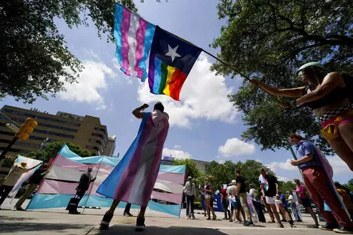 Demonstrators gather on the steps to the State Capitol to speak against transgender-related legislation bills being considered in the Texas Senate and Texas House, May 20, 2021, in Austin, Texas. A Texas judge on Friday, June 10, 2022, temporarily blocked the state from investigating families of transgender children who have received gender-confirming medical care, a new obstacle to the state labeling such treatments as child abuse. (AP Photo/Eric Gay, File)