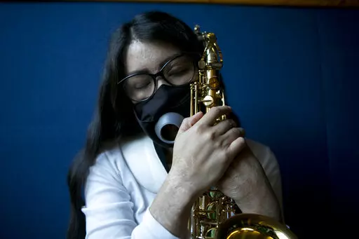 Maria Elena Ríos holds her saxophone at the end of a rehearsal at the National Autonomous University of Mexico music department, in Mexico City, Tuesday, Feb. 14, 2023. Ríos, 29, thought her career as a musician and her devotion to hersaxwas what ledherformer boyfriend and politician to hire the men who splashed acid into her faceand body, disfiguring her in 2019. Later, she learned that he simply couldn't accept that she had broken off their relationship. (AP Photo/Ginnette Riquelme)