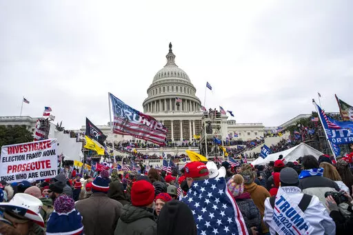 Rioters loyal to President Donald Trump rally at the U.S. Capitol in Washington on Jan. 6, 2021. The House committee investigating the Jan. 6 attack on the U.S. Capitol has scheduled its next hearing for Oct. 13, 2022, pushing the investigation back into the limelight less than three weeks before the midterm election that will determine control of Congress. (AP Photo/Jose Luis Magana, File)