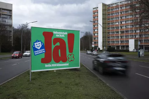 A poster with a huge "Yes", advertising a climate referendum stands out along a street in Berlin, Friday, March 24, 2023. Voters in Berlin go to the polls this weekend to decide on a proposal that would force the city government to drastically ramp up the German capital’s climate goals. Sunday's referendum, which has attracted considerable financial support from U.S.-based philanthropists, calls for Berlin to become climate neutral by 2030, meaning that within less than eight years the city wo