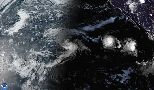 This satellite image provided by the National Oceanic and Atmospheric Administration (NOAA) shows Tropical Storm Hone and Hurricane Gilma located southeast of Hawaii, Thursday, Aug. 22, 2024. (NOAA via AP)