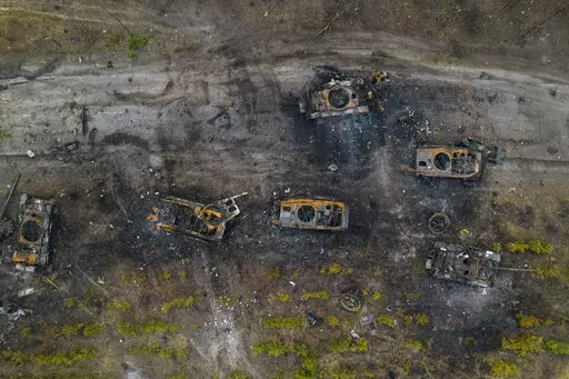 Destroyed Russian armored vehicles sit on the outskirts of Kyiv, Ukraine, March 31, 2022. In the year since Russia invaded Ukraine, disinformation and propaganda have emerged as key weapons in the Kremlin's arsenal. (AP Photo/Rodrigo Abd, File)