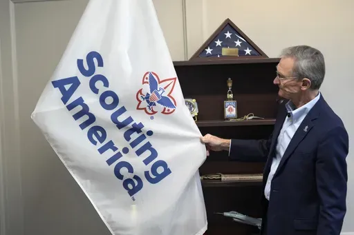 Roger Krone, chief executive officer of Scouting America, describes the design of the organization's flag in Irving, Texas, Wednesday, Feb. 5, 2025. (AP Photo/LM Otero)