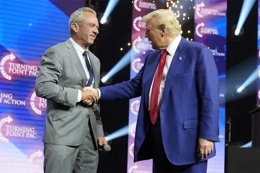 Republican presidential nominee former President Donald Trump greets Robert F. Kennedy Jr., at a Turning Point Action campaign rally, Oct. 23, 2024, in Duluth, Ga. (AP Photo/Alex Brandon)