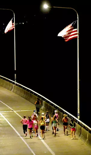 A group of runners cross the Veteran's Bridge as they return to Girls Preparatory School as they take part in  "Finish Eliza's Run" on Friday, Sept. 9, 2022 in Chattanooga, Tenn. The approximately four mile run was to memorialize, Eliza Fletcher, the Memphis runner, and mother of two, who was murdered during her early morning run.   (Robin Rudd /Chattanooga Times Free Press via AP)