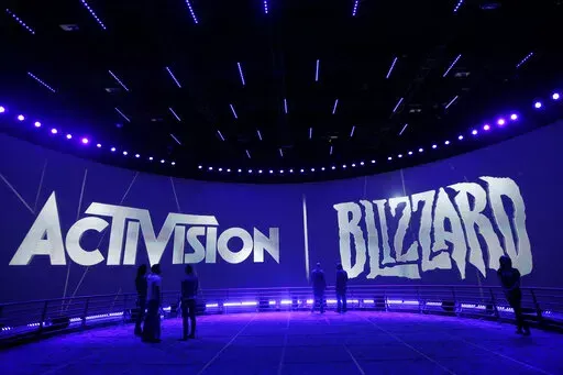 The Activision Blizzard Booth is shown on June 13, 2013 the during the Electronic Entertainment Expo in Los Angeles. Microsoft is buying Activision Blizzard, Tuesday, Jan. 18, 2022,  for $68.7 billion to gain access to blockbuster games including Call of Duty and Candy Crush. The all-cash deal will let Microsoft accelerate mobile gaming and provide it building blocks for the metaverse, or a virtual environment.  (AP Photo/Jae C. Hong, File)