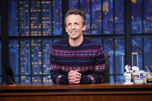 This image released by NBC shows Seth Meyers on "Late Night with Seth Meyers" in New York on Dec. 16, 2021. This week’s remaining episodes have been scrapped after the Meyers tested positive for COVID-19. Meyers tweeted Tuesday his positive result but said he felt fine, thanking the vaccine and a booster. NBC has canceled shows scheduled from Tuesday to Friday.  (Lloyd Bishop/NBC via AP)