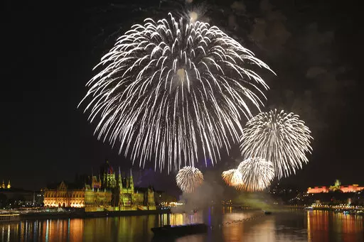 Fireworks illuminate the skies over Budapest, Hungary, Saturday, Aug. 27, 2022. An elaborate fireworks display took place Saturday under calm skies in Hungary's capital after a postponement of the show last weekend caused controversy when it led to the firing of the country's top meteorologists over their weather predictions. (AP Photo/Csaba Domotor)