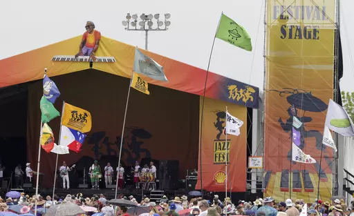 Flags fly in front of the Festival Stage during the New Orleans Jazz & Heritage Festival on May 7, 2023. The Fair Grounds Race Course, which plays host to the 2024 New Orleans Jazz and Heritage Festival, begins its annual transformation in earnest Tuesday, March 26, 2024, as organizers prepare to take over the field this Spring for two weekends of music, food and fun. (Brett Duke/The Advocate via AP, File)