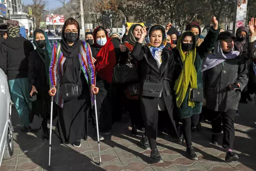 Afghan women chant slogans during a protest against the ban on university education for women, in Kabul, Afghanistan, Thursday, Dec. 22, 2022. The U.S. has condemned the Taliban for ordering non-governmental groups in Afghanistan to stop employing women, saying the ban will disrupt vital and life-saving assistance to millions. It is the latest blow to female rights and freedoms since the Taliban seized power last year and follows sweeping restrictions on education, employment, clothing and trave