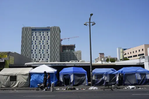 Tents are lined up on Skid Row Thursday, July 25, 2024, in Los Angeles. California Gov. Gavin Newsom issued an executive order Thursday to direct state agencies on how to remove homeless encampments, a month after a Supreme Court ruling allowing cities to enforce bans on sleeping outside in public spaces. (AP Photo/Jae C. Hong)