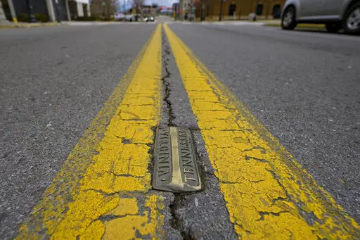 Brass markers, marking the state line between Bristol, Tenn. and Bristol, Va., line State Street in Bristol, Va., on Thursday, Feb. 23, 2023. Residents in southwestern Virginia have battled for months over whether abortion clinics limited by strict laws in other states should be allowed to hop over the border and operate there. Similar scenarios are beginning to play out in communities along state lines around the country since the U.S. Supreme Court overturned Roe v. Wade. (AP Photo/Earl Neikir