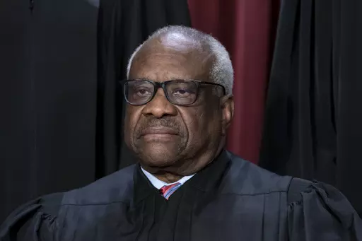 Associate Justice Clarence Thomas joins other members of the Supreme Court as they pose for a new group portrait, at the Supreme Court building in Washington, Oct. 7, 2022. Conservative mega-donor Harlan Crow purchased three properties belonging to Thomas and his family, in a transaction worth more than $100,000 that Thomas never reported, according to the non-profit investigative journalism organization ProPublica on Thursday, April 13, 2023. (AP Photo/J. Scott Applewhite, File)