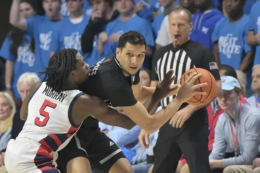 Mississippi guard Jaylen Murray (5) fouls Mississippi State forward RJ Melendez during the first half of an NCAA college basketball game in Oxford, Miss., Saturday, Feb. 15, 2025. (AP Photo/Bruce Newman)
