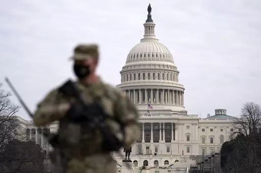 A member of the National Guard patrols the area outside of the U.S. Capitol at the Capitol in Washington, Wednesday, Feb. 10, 2021. The House passed a defense policy bill Thursday, Dec. 14, 2023, that authorizes the biggest pay raise for troops in more than two decades, overcoming objections from some conservatives concerned the measure did not do enough to restrict the Pentagon's diversity initiatives, abortion travel policy and gender-affirming health care for transgender service members. (AP 