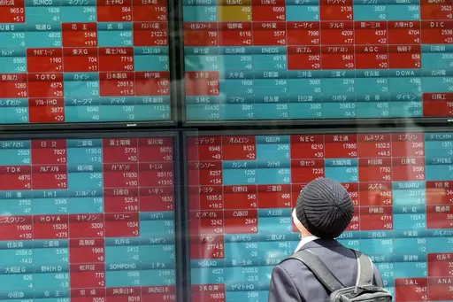 A person looks at an electronic stock board showing Japan's Nikkei 225 index at a securities firm Friday, May 12, 2023, in Tokyo. Asian shares were mostly lower Friday on looming worries over U.S. banks and lagging demand from China, the region's major driver of growth. (AP Photo/Eugene Hoshiko)