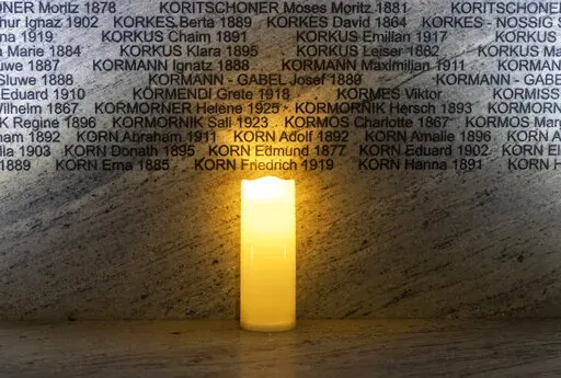 FILE -A light illuminates names at the Shoah Wall of Names Memorial during the inauguration ceremony, in Vienna, Austria, Nov. 9, 2021. Vienna born Holocaust survivor Gertrude Pressburger, who became famous during the 2016 presidential campaign in Austria with a video message in which as "Mrs. Gertrude" she warned of hatred and exclusion triggered by the far right, has died at age 94. (AP Photo/Lisa Leutner, File)