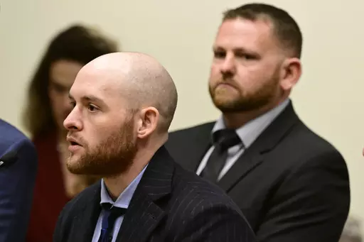 Former Officer Jason Rosenblatt, left, and Aurora Police Officer Randy Roedema, right, attend an arraignment at the Adams County Justice Center in Brighton, Colo., Jan. 20, 2023. The two officers face felony charges in the 2019 death of Elijah McClain. (Andy Cross/The Denver Post via AP, File)