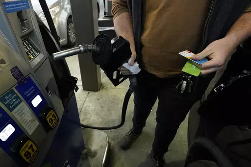 A customer prepares to pump gasoline into his car at a Sam's Club fuel island in Gulfport, Miss., Feb. 19, 2022. The U.S. economy shrank last quarter for the first time since the pandemic recession struck two years ago, Thursday, April 28, 2022, contracting at a 1.4% annual rate, but consumers and businesses kept spending in a sign of underlying resilience.  (AP Photo/Rogelio V. Solis)