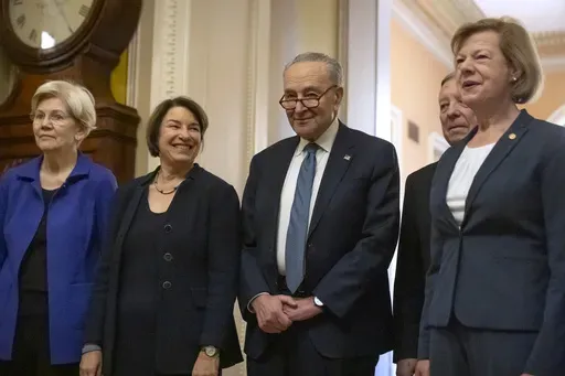 Senators, from left, Sen. Elizabeth Warren, D-Mass., Sen. Amy Klobuchar, D-Minn., Senate Majority Leader Chuck Schumer of N.Y., Sen. Dick Durbin, D-Ill., and Sen. Tammy Baldwin, D-Wis., gather after Senate Democratic leadership elections for the next session of Congress on Capitol Hill, Tuesday, Dec. 3, 2024, in Washington. (AP Photo/Mark Schiefelbein)