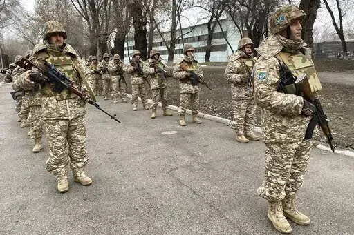 In this photo released by the Russian Defense Ministry Press Service, Collective Security Treaty Organization peacekeepers prepare to guard an area in Almaty, Kazakhstan, Tuesday, Jan. 11, 2022. The president of Kazakhstan has announced that a Russia-led security alliance will start pulling out its troops from the Central Asian country in two days after completing its mission. The mostly Russian troops were deployed to Kazakhstan last week by the Collective Security Treaty Organization, an allia