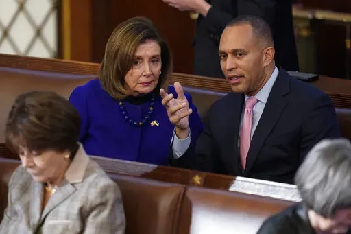 Rep. Hakeem Jeffries, D-N.Y., right, talks with Rep. Nancy Pelosi, D-Calif., during the eighth vote in the House chamber as the House meets for the third day to elect a speaker and convene the 118th Congress in Washington, on Jan. 5, 2023. Democrats are basking in having displayed remarkable unity, with every one of their members backing party leader Hakeem Jeffries for the House speakership again and again and again. Speculation Biden might have to overcome a hard Democratic primary has also qu