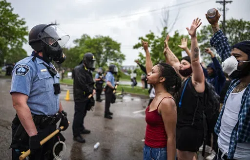 Protesters and police face each other during a rally for George Floyd in Minneapolis on May 26, 2020. Almost two years after George Floyd died at the hands of four Minneapolis police officers, Minnesota's Department of Human Rights was set Wednesday, April 27, 2022,  to announce findings from its investigation into whether the city police department had a pattern or practice of racial discrimination in policing. (Richard Tsong-Taatarii/Star Tribune via AP)