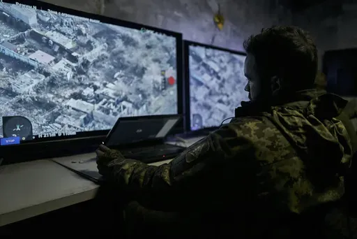 A Ukrainian soldier watches a drone feed from an underground command center in Bakhmut, Donetsk region, Ukraine, Sunday, Dec. 25, 2022. (AP Photo/Libkos, File)