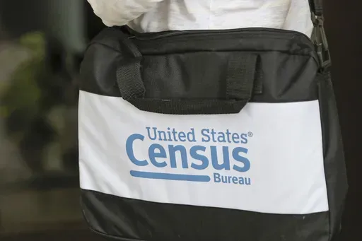 A census taker's briefcase is visible as she knocks on doors, Aug. 11, 2020, in Winter Park, Fla. A report released Tuesday, July 9, 2024, by the American Statistical Association warns that U.S. statistical agencies lack protections against political interference and adequate funding. (AP Photo/John Raoux, File)