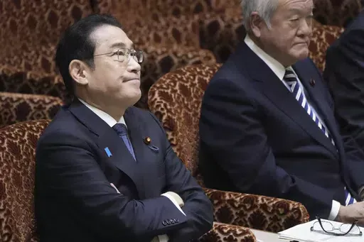 Japanese Prime Minister Fumio Kishida, left, and Finance Minister Shunichi Suzuki, right, attend a parliamentary session of House of Councilors in Tokyo, Monday, March 25, 2024. North Korea said Monday that Prime Minister Kishida has proposed a summit with North Korean leader Kim Jong Un, as the North urged Japan to show sincerity toward improving bilateral ties and realizing their countries’ first summit in about 20 years.(Kyodo News via AP)