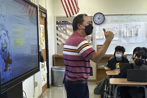 This photo shows Daniel Santos, a middle school history teacher during class, in Houston, in November, 2021. Teachers around the U.S. are confronting classrooms where as many as half of students are absent. That's because they have been exposed to COVID-19 or their families kept them at home out of concern about the surging coronavirus. F  (Courtesy Daniel Santos via AP)