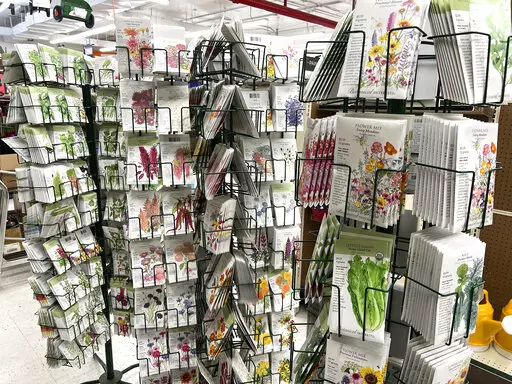 This Jan. 23, 2022 image provided by Jeff Lowenfels shows seed packets for sale on in Anchorage, Alaska. Seed racks are back in stores promising all kinds of abundance in the gardening season ahead. Be careful approaching them, those seed packets can lure you in with pretty pictures on the front. But it's the advice on the back you need to follow. (Jeff Lowenfels via AP)