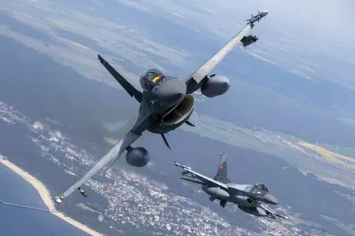 A Romanian Air Force F- 16s military fighter jet, left, and a Portuguese Air Force F- 16s military fighter jets participating in NATO's Baltic Air Policing Mission operate over the Baltic Sea, Lithuanian airspace, on May 22, 2023. The United States has given its approval for the Netherlands to deliver F-16s to Ukraine, the Dutch defense minister said Friday, Aug. 18, 2023 in a major gain for Kyiv even though the fighter jets won’t have an immediate impact on the almost 18-month war. (AP Photo/