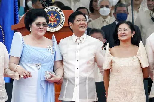 President Ferdinand Marcos Jr. stands with his mother Imelda Marcos, left, and his wife Maria Louise Marcos, right, during the inauguration ceremony at National Museum on Thursday, June 30, 2022 in Manila, Philippines. Marcos was sworn in as the country's 17th president. (AP Photo/Aaron Favila)