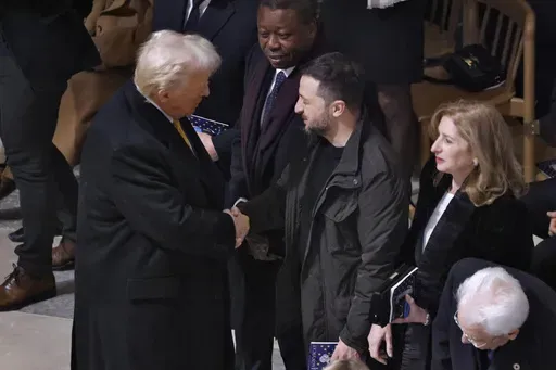 President-elect Donald Trump shakes hands with Ukraine's President Volodymyr Zelenskyy in Notre Dame Cathedral as France's iconic cathedral is formally reopening its doors for the first time since a devastating fire nearly destroyed the 861-year-old landmark in 2019, Saturday Dec.7, 2024 in Paris ( Ludovic Marin, Pool via AP)