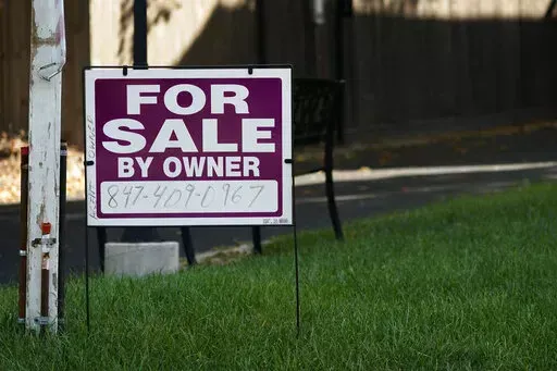 For sale by owner sign is displayed outside home in Northbrook, Ill., Wednesday, Sept. 21, 2022. Average long-term U.S. mortgage rates rose this week for the sixth straight week, marking new highs not seen in 15 years, before a crash in the housing market triggered the Great Recession, mortgage buyer Freddie Mac reported Thursday, Sept. 29, 2022. (AP Photo/Nam Y. Huh)
