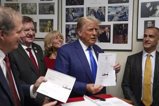 Republican presidential candidate former President Donald Trump talks as New Hampshire Secretary of State David Scanlan, left, listens as he signs papers to be on the 2024 Republican presidential primary ballot at the New Hampshire Statehouse, Monday, Oct. 23, 2023, in Concord, N.H. At right is Corey Lewandowski. (AP Photo/Charles Krupa)