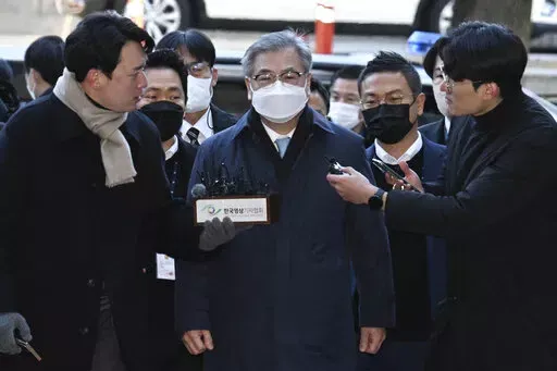 Former South Korean National Security Director Suh Hoon, center, arrives at the Seoul Central District Court in Seoul, South Korea, Friday, Dec. 2, 2022. South Korean prosecutors arrested the country’s former national security director on Saturday over suspicions that he engaged in a cover-up to hide details and distort the circumstances surrounding North Korea’s killing of a South Korean fisheries official near the rivals’ sea boundary in 2020. (Han Sang-kyun/Yonhap via AP)